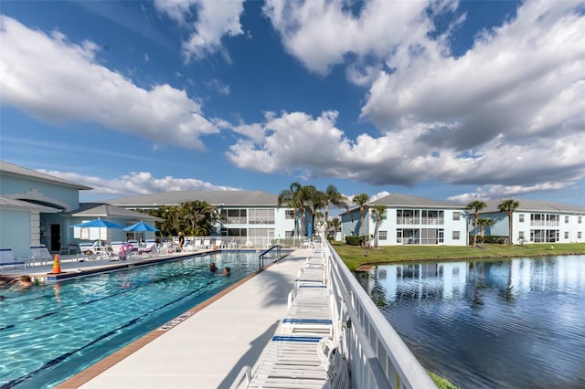 view of swimming pool featuring a water view