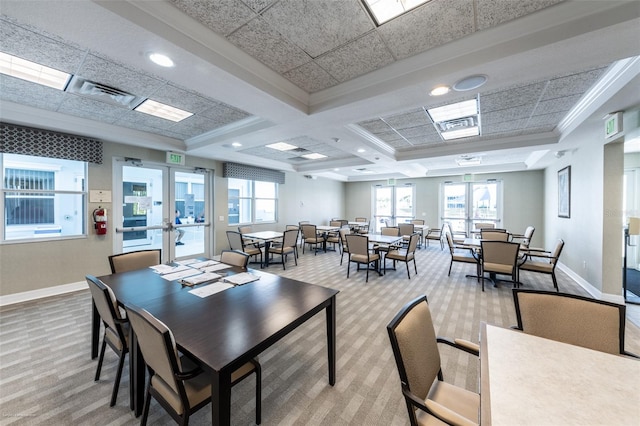 dining space with coffered ceiling, crown molding, french doors, and carpet flooring