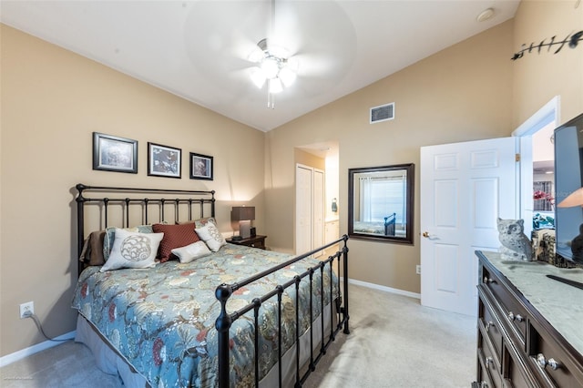 carpeted bedroom featuring vaulted ceiling, ceiling fan, and a closet