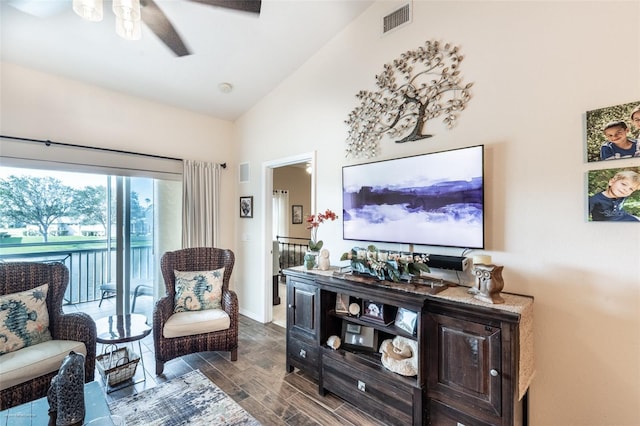 living room with dark wood-type flooring, ceiling fan, and lofted ceiling