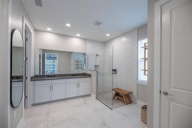 bathroom with vanity and tiled shower