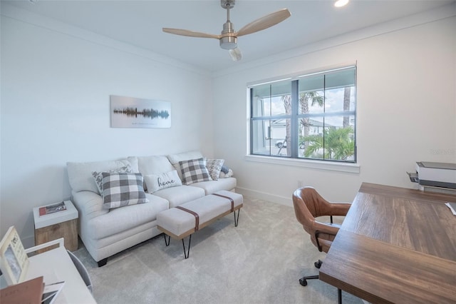 carpeted office featuring ceiling fan and crown molding