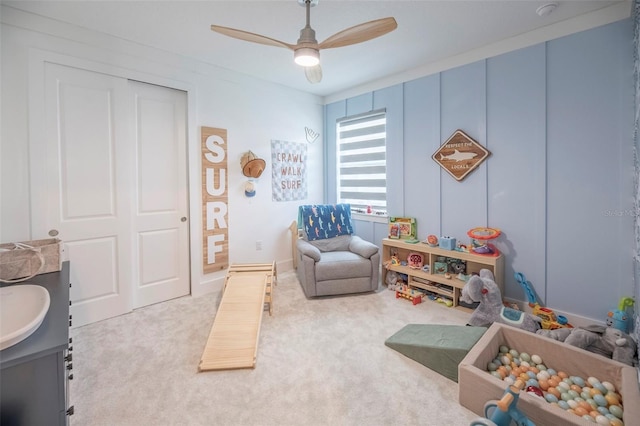 game room featuring carpet floors, sink, and ceiling fan