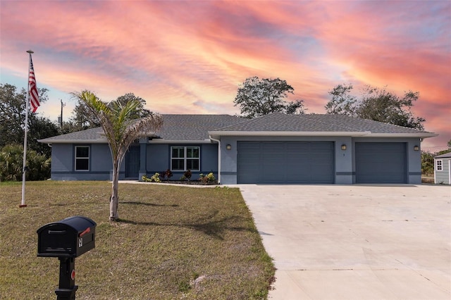 single story home featuring a yard and a garage