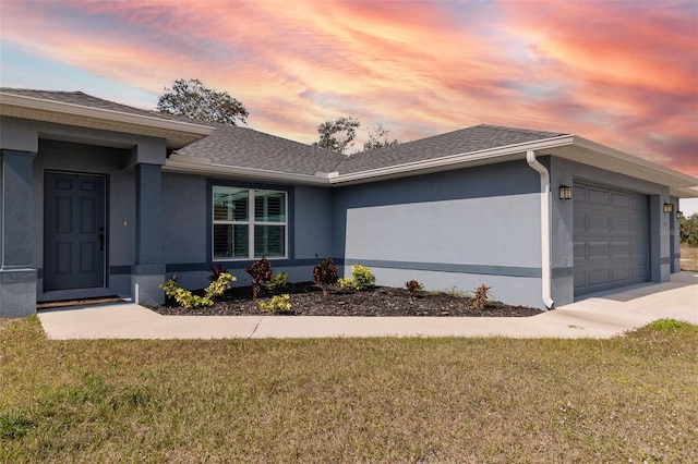 property exterior at dusk with a yard and a garage