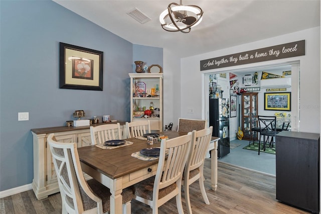 dining space featuring an inviting chandelier and hardwood / wood-style floors