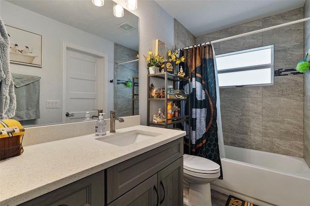 full bathroom with vanity, shower / bath combo, and toilet