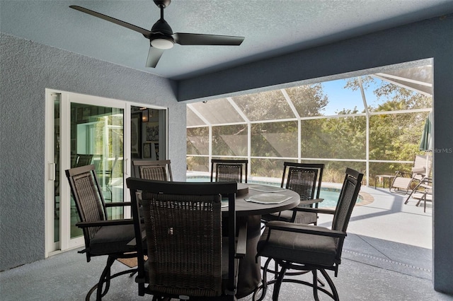 view of patio / terrace with ceiling fan and glass enclosure