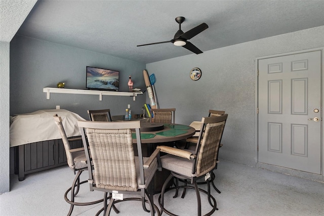 dining area featuring a textured ceiling and ceiling fan