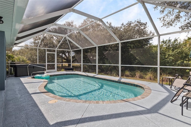 view of pool featuring a lanai and a patio