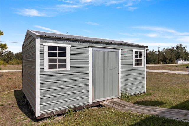 view of outdoor structure with a lawn