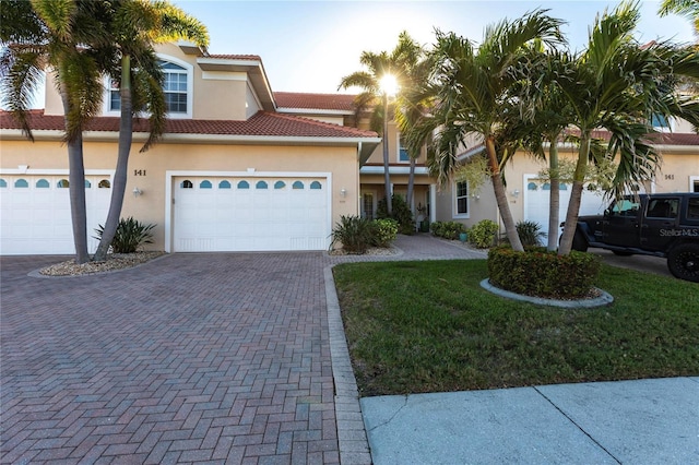 view of front facade with a garage and a front lawn