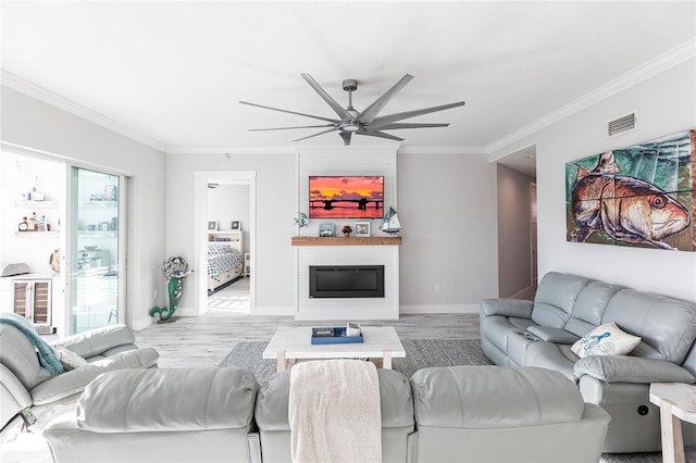 living room featuring crown molding, ceiling fan, and light hardwood / wood-style flooring