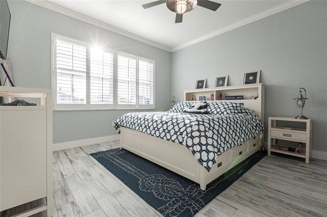 bedroom with ceiling fan, ornamental molding, and hardwood / wood-style floors