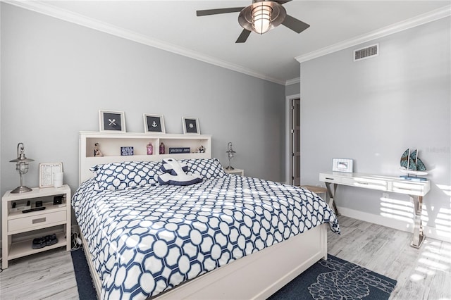 bedroom with crown molding, ceiling fan, and wood-type flooring