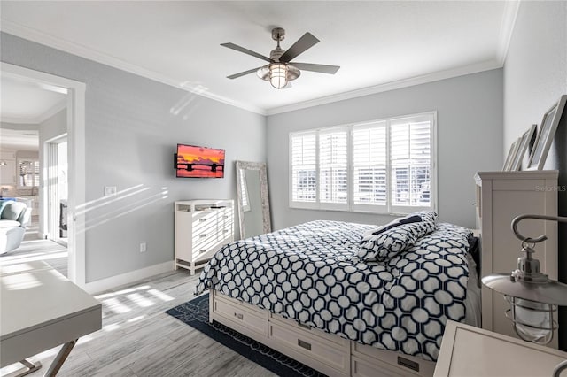 bedroom with ornamental molding, light hardwood / wood-style floors, and ceiling fan