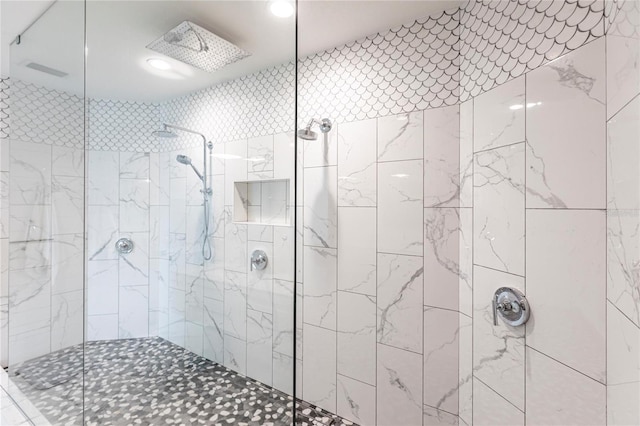 bathroom with tiled shower