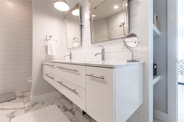 bathroom featuring walk in shower, vanity, and toilet