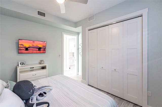 bedroom with a closet, ceiling fan, and light wood-type flooring