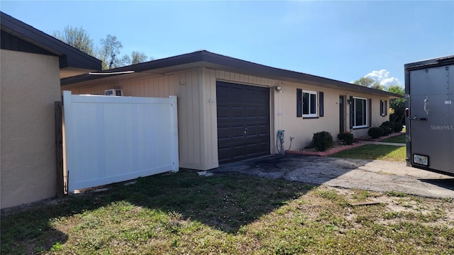 view of home's exterior featuring a garage and a lawn