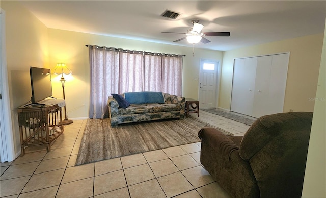 tiled living room featuring ceiling fan