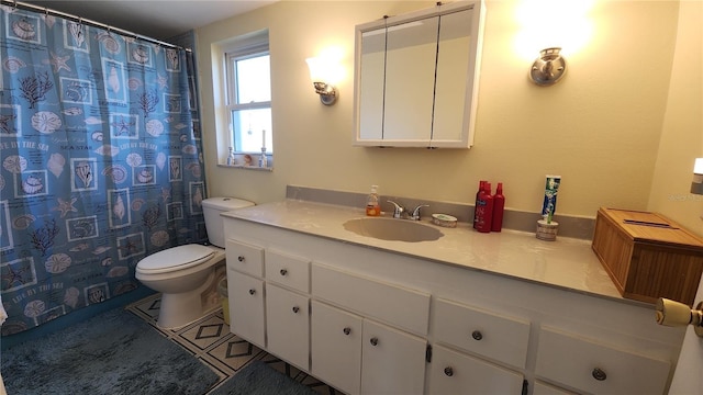 bathroom with tile patterned flooring, vanity, and toilet