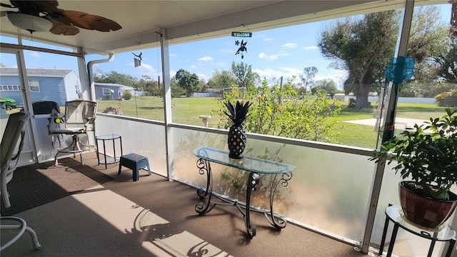 sunroom / solarium featuring ceiling fan