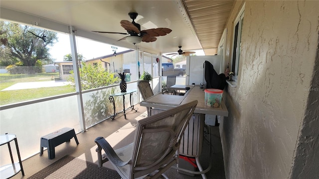 sunroom / solarium featuring ceiling fan