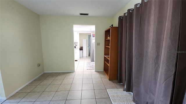 corridor with light tile patterned floors