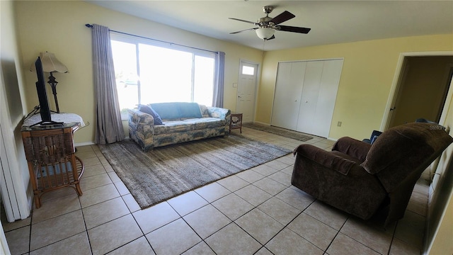 tiled living room with ceiling fan