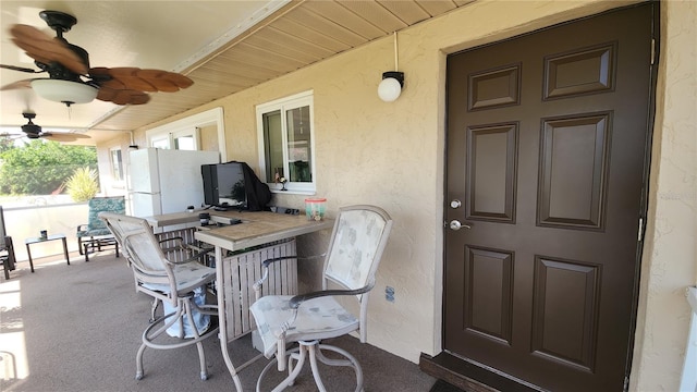 view of patio / terrace featuring exterior bar and ceiling fan