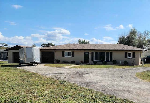 181 Coconut St, Punta Gorda, FL 33980 - ranch-style house with driveway, an attached garage, a front lawn, and stucco siding