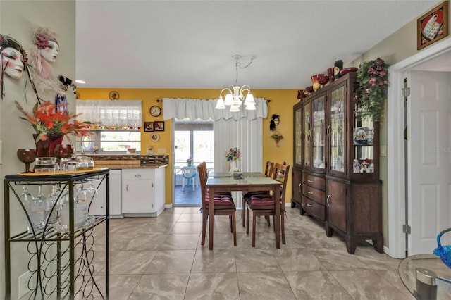 tiled dining space featuring a chandelier