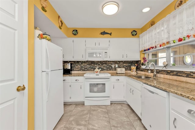 kitchen featuring tasteful backsplash, sink, white cabinets, light stone counters, and white appliances