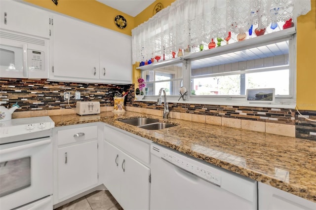 kitchen with white cabinetry, white appliances, sink, and tasteful backsplash