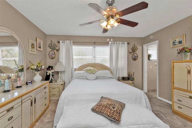 bedroom with multiple windows and ceiling fan