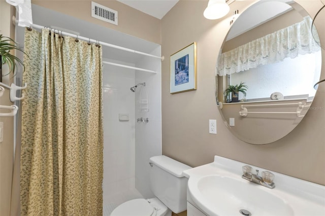 bathroom featuring walk in shower, vanity, and toilet