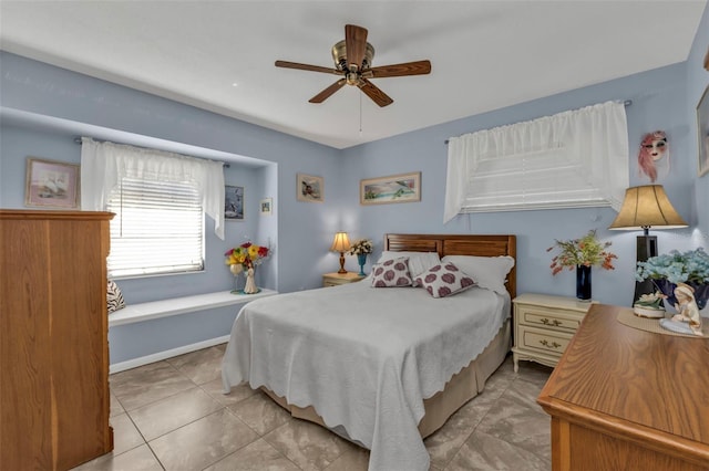 bedroom featuring light tile patterned floors and ceiling fan