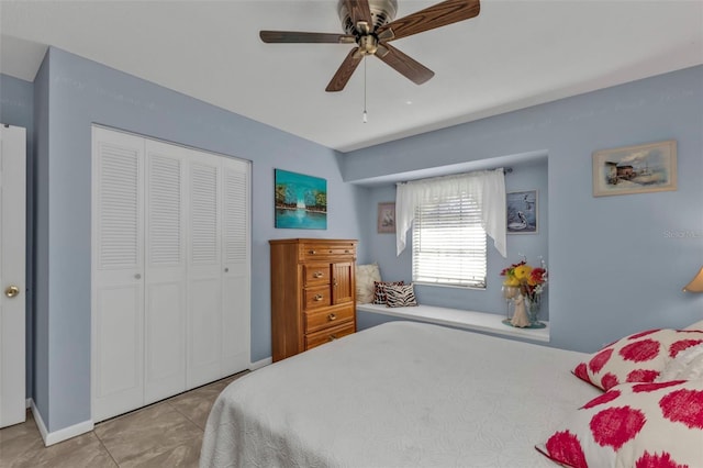 bedroom featuring ceiling fan, a closet, and light tile patterned floors