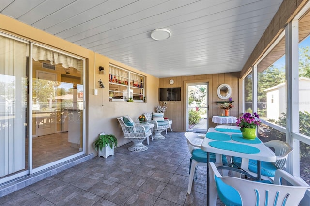 sunroom / solarium featuring wood ceiling