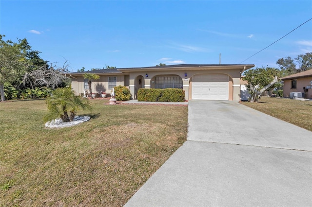 single story home with a garage, a front yard, and central air condition unit