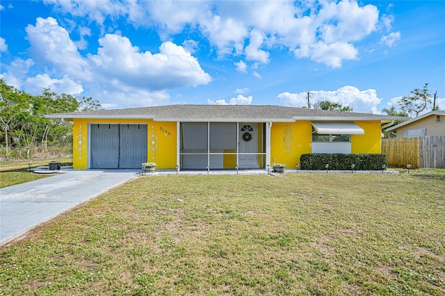 ranch-style house featuring a garage and a front lawn