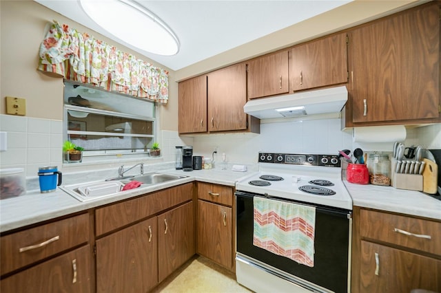 kitchen featuring sink, electric range, and backsplash