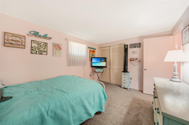 bedroom featuring light colored carpet and a closet