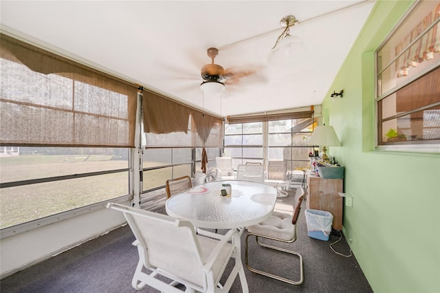 sunroom / solarium featuring ceiling fan