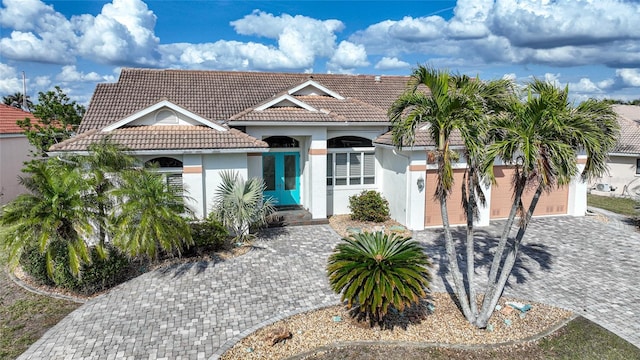 mediterranean / spanish-style house with a garage