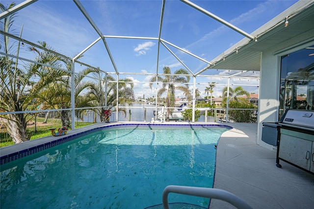 view of pool featuring a lanai, a patio area, and a water view