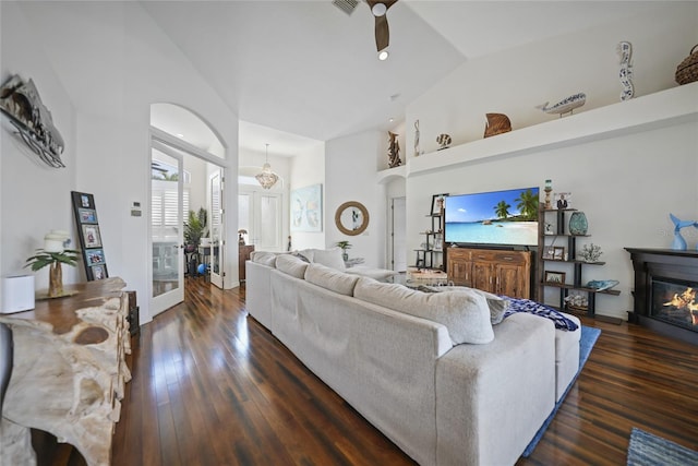 living room with high vaulted ceiling, dark hardwood / wood-style floors, and ceiling fan