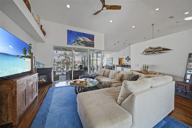 living room with high vaulted ceiling, dark hardwood / wood-style floors, and ceiling fan