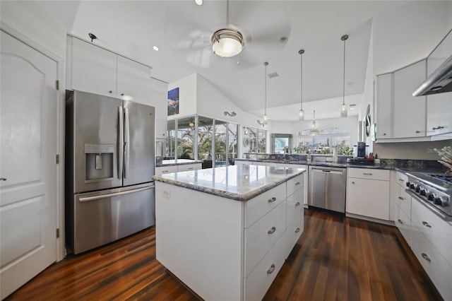 kitchen with a kitchen island, dark hardwood / wood-style floors, white cabinets, hanging light fixtures, and stainless steel appliances